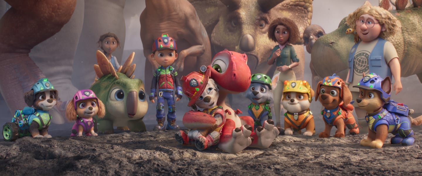 Carter Young as “Marshall” gets a hug from Rhubarb in PAW Patrol: The Dino Movie from Paramount PIctures and Spinmaster. 